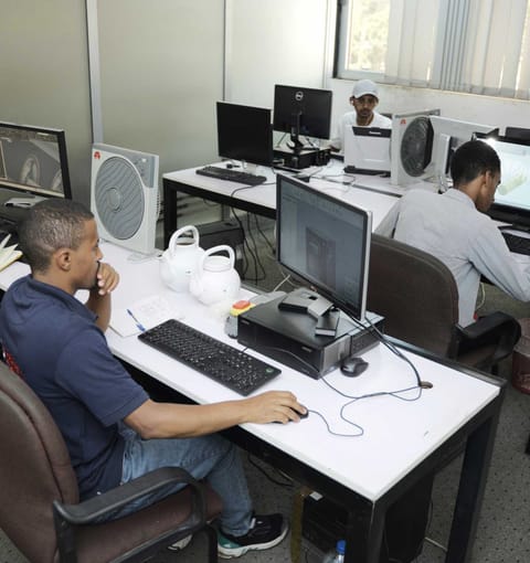 ZG engineers reviewing a 3D CAD model of a machine part on a workstation monitor