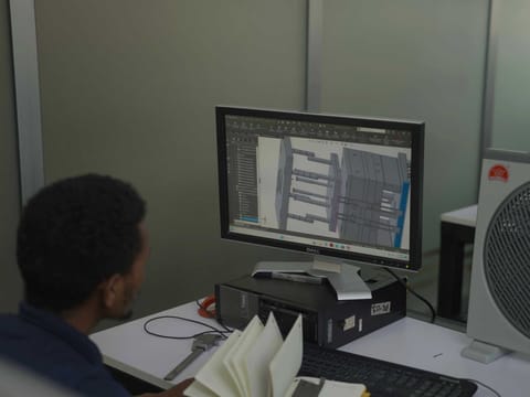 A technical assembly drawing displayed on a workstation monitor