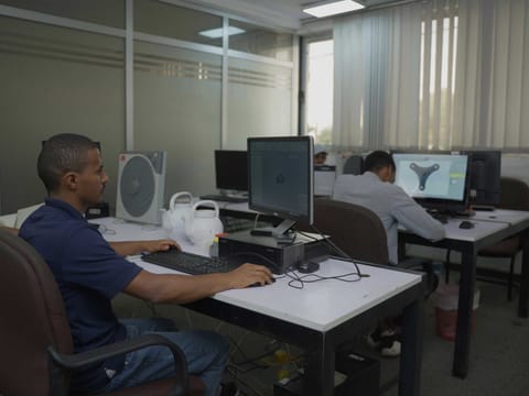 Two engineers working side by side at CAD workstations