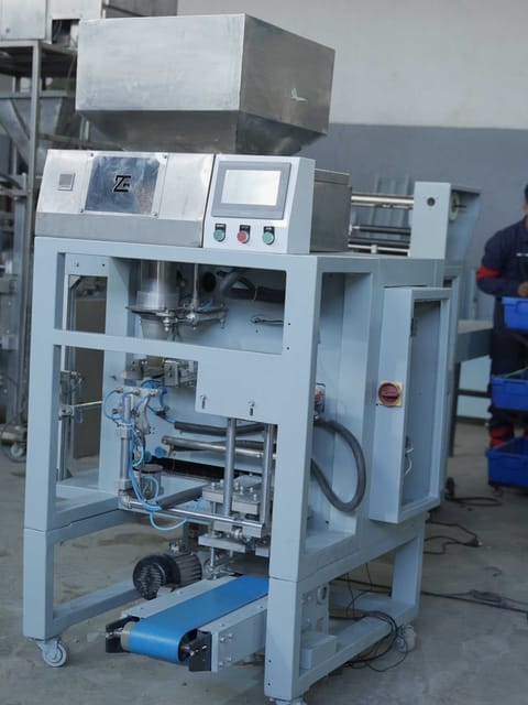 Vertical form fill seal machine with product hopper and ZG-branded touchscreen control panel